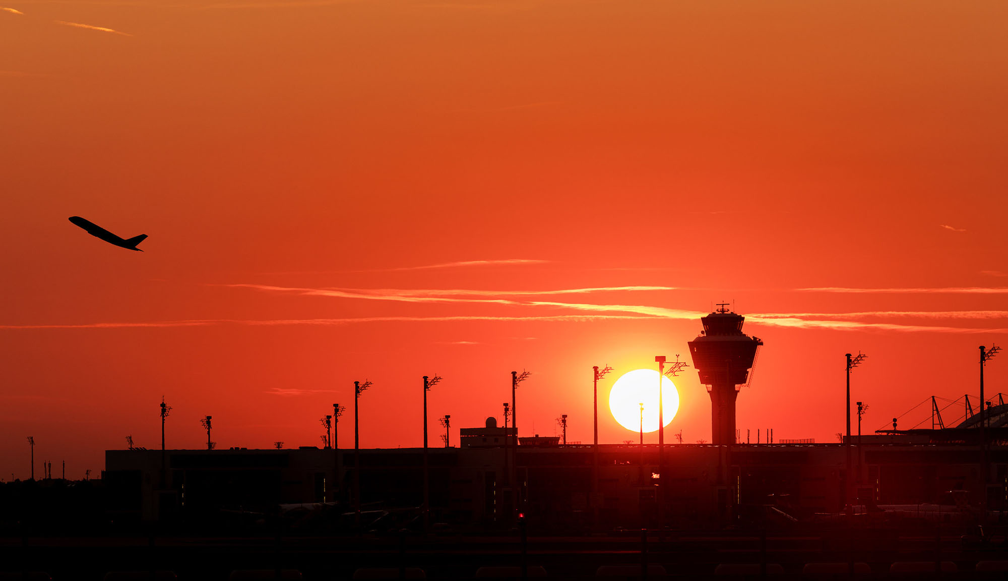 Air traffic control tower against sunset