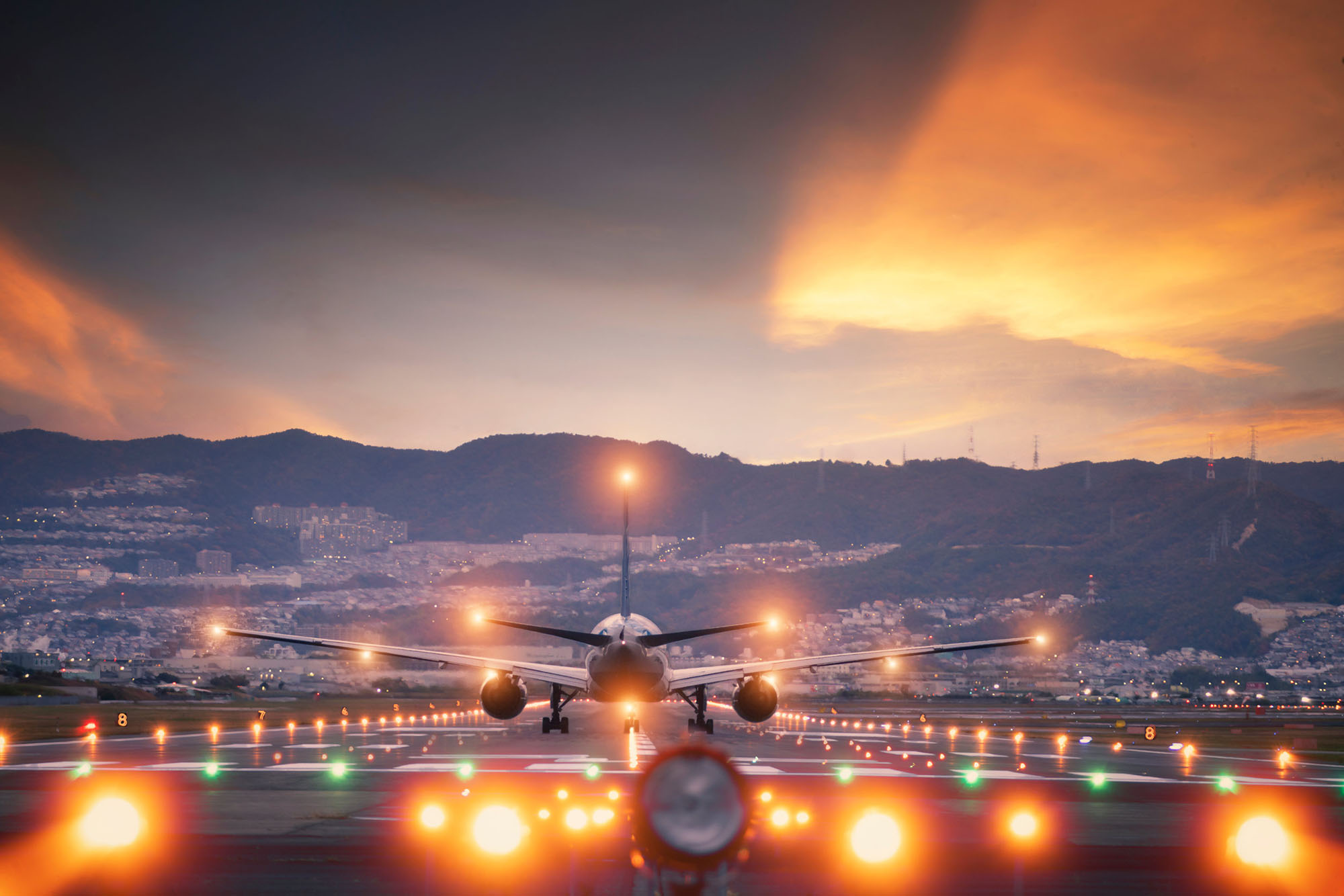 Airplane on runway, from rear